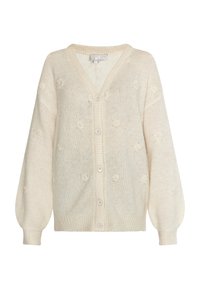 Krämfärgad cardigan med V-hals, knapplåsning och blommig stickad struktur. Puffärmar och ribbade manschetter ger distinkta detaljer.