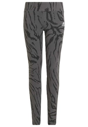 Leggings grises con un patrón de rayas de tigre negras, hechos de un material elástico y con una cintura alta, diseñados para la comodidad y el movimiento.