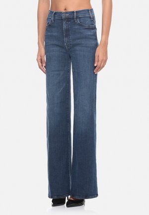 Jeans a vita alta e gamba larga in denim blu scuro. Presentano un classico design a cinque tasche e dettagli di cucitura discreti. Tessuto liscio.