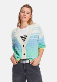 Lightweight cardigan in blue, green, and white striped knit. Features a deep V-neck, three buttons, and ribbed cuffs with yellow accents.