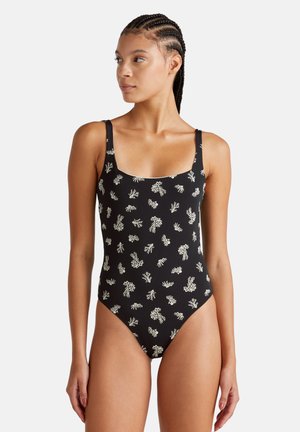 Zwart badpak met witte koraalpatroon, vierkante halslijn en dunne bandjes. Beschikt over hoge uitsnijdingen voor de benen en een gladde textuur.
