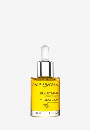 Szklana butelka z metalową nakrętką w kolorze srebrnym, zawierająca żółty serum oznaczone jako "Sérum Phytarosa", 30 ml, minimalistyczny design na białym tle.