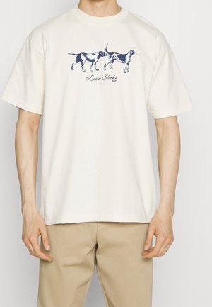 Cream cotton t-shirt featuring a blue dog graphic with the text "Love Stinks" underneath. Short sleeves and a classic crew neck design.