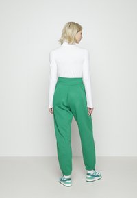 Nike Sportswear W PHNX FLC HR OS - Calças de fato de treino - malachite