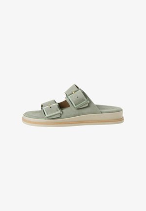 Light green suede slide sandal with two rectangular buckles, a tan insole, and a cream rubber sole. Flat design with no heel.