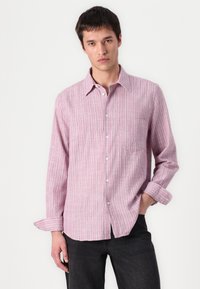 Pink striped shirt in lightweight fabric, featuring a button-down collar, long sleeves, and a chest pocket. Textured with subtle lines.
