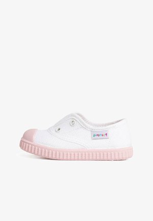 White canvas slip-on shoe with a textured surface, pink rubber toe cap, and a pink rubber sole. Eyelet detailing for ventilation.