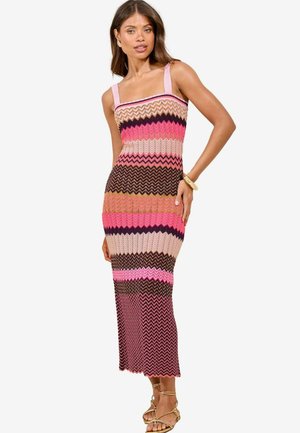 Knitted, multicolored zigzag pattern dress featuring wide straps, a form-fitting silhouette, and a knee-length hem.