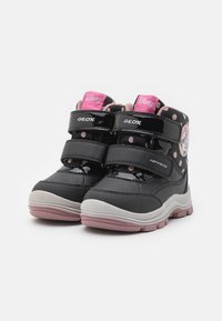 Černé vysoké tenisky s růžovými akcenty, design v puntíky, dvojité suché zipy a gumová podrážka s šedými a růžovými prvky.