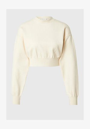 Lühendatud kreemivärvi kampsun pika, puhv-ägega ja kõrge kaelusega. Ominab tekstureeritud kudumkangast ja ribakujulisi varrukaotsi, mis tagavad mugava istuvuse.