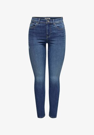 Uske uske mršavi traperice u tamnoplavom denimu. Karakteristike uključuju pet džepova, petlje za pojas i suptilno trošenje na lijevom bedru. Glatka tekstura.