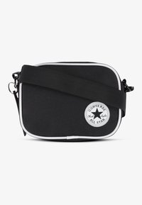 Borsa a tracolla nera in tessuto con dettagli bianchi, forma rettangolare, cinturino regolabile e una trama circolare con il logo Converse sulla parte anteriore.
