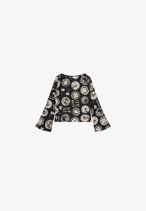 Zwarte lange mouwen top met uitlopende mouwen en een crèmekleurig circulair motief. Lichtgewicht stof, met een ronde halslijn en een sluiting aan de achterkant.
