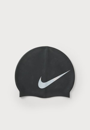 Black silicone swim cap with a smooth texture and a prominent white Nike swoosh logo on the front; rounded shape with a secure fit.