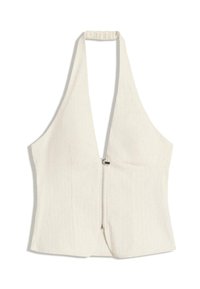 Top halter în bej deschis, cu un decolteu adânc în V și un fermoar în față. Materialul are o textură subtilă, cu panouri structurate și fără mâneci.