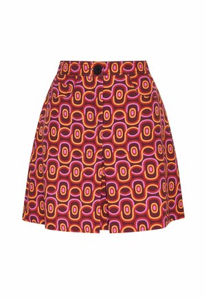 A multicolored mini skirt featuring a geometric pattern of circular shapes in oranges, pinks, and browns, with a front button closure and pockets.