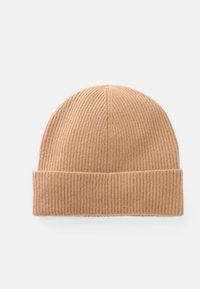 Knit beanie in light tan, with ribbed texture and a folded cuff. Simple, functional design without additional embellishments.