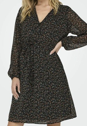 Sort blomsterkjole med lange ærmer, V-hals og en indsnævret talje. Fremstillet i let, gennemsigtigt stof med flerfarvede blomstertryk.