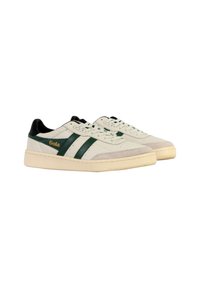 White sneakers with green stripes, black accents, suede toe cap, and flat laces. Rubber sole with a textured finish. Gola logo in gold.