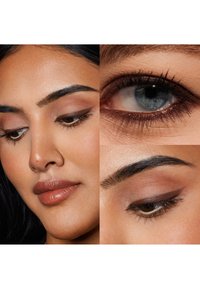 Primo piano di un volto con un incarnato uniforme, labbra leggermente pigmentate, sopracciglia definite e un trucco sugli occhi sottile con tonalità di marrone e beige.