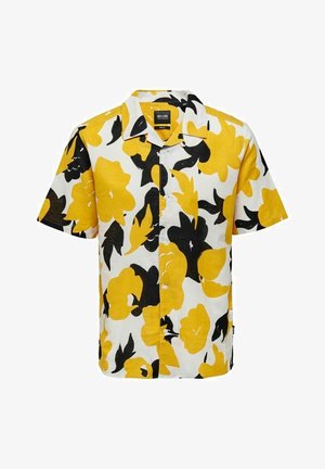 Camisa de manga corta con un atrevido patrón floral en amarillo y negro sobre un fondo blanco. Hecha de un tejido ligero con un corte holgado.