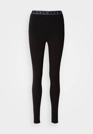 Black leggings made of stretchy material, featuring a branded waistband with "TOMMY JEAN" in white text. Designed with a fitted silhouette.