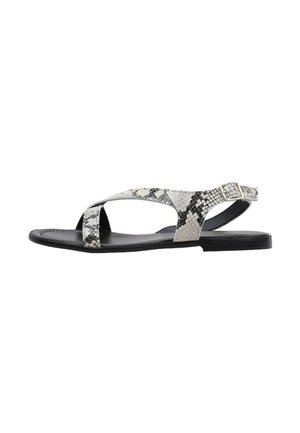 Sandalias planas con un diseño de estampado de serpiente en blanco y negro, con una tira cruzada y hebilla en el tobillo, fabricadas en un material sintético texturizado.