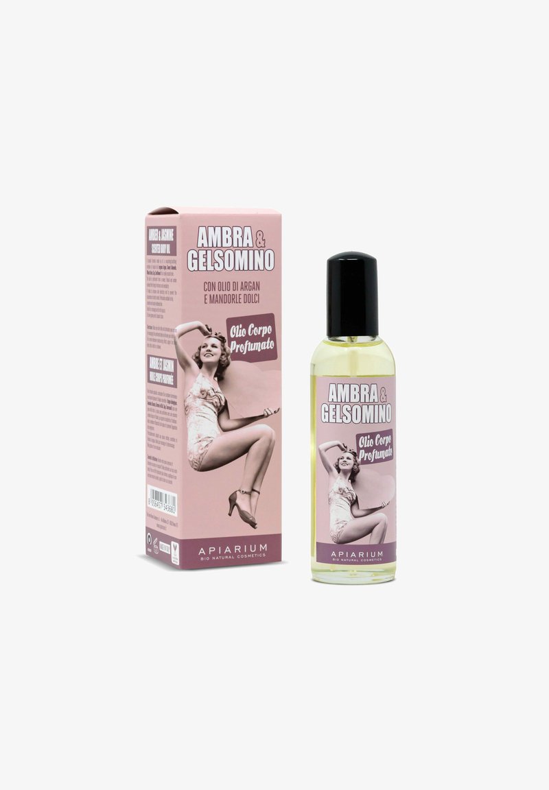 Olio corpo profumato Ambra & Gelsomino con argan e mandorla dolce, con immagine di donna pin-up vintage su confezione rosa e bottiglia trasparente con tappo nero.