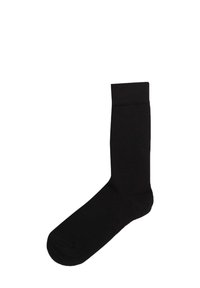 Calzino in cotone nero con una texture liscia e un polsino rinforzato. Lunghezza standard da crew, chiusura della punta senza cuciture e design minimale.