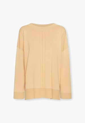 Licht perzikkleurige gebreide trui met een ronde hals, verlaagde schouders en drie verticale plooien aan de voorkant. Geribbelde manchetten en zoom.