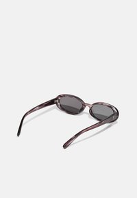 Round, purple-tinted sunglasses with a marbled acetate frame and dark lenses; slim arms feature gold accent detail at the temple.