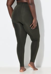 Olivgrüne Leggings aus dehnbarem Material, mit hohem Bund und figurbetontem Design, das eine dezente Textur aufweist und keine sichtbaren Nähte hat.
