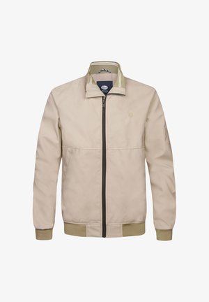 Beige jas met ritssluiting en een opstaande kraag, voorzien van een donkere rits en bijpassende geribbelde manchetten. Geaccentueerd met een groene en witte gestreepte binnenkraag.