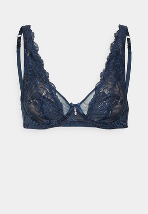 Reggiseno in pizzo blu navy con spalline regolabili, dettagli floreali, pannelli in rete trasparente e un piccolo gioiello decorativo al centro frontale.