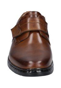 Brown leather shoe with a smooth texture, featuring two adjustable Velcro straps and a rounded toe, set on a black sole with stitching detail.