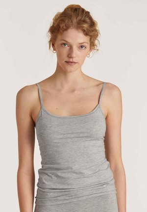 Gray tank top with thin straps, made of soft, lightweight material. Features a fitted design and minimal seams for comfort.
