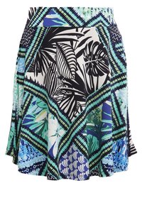 Jupe évasée avec un motif vibrante de feuilles tropicales noires et bleues sur fond blanc, présentant un design géométrique vert. Tissu extensible.
