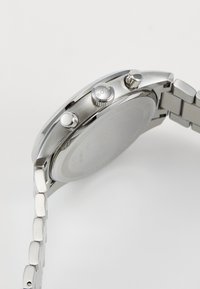 Stainless steel watch with a silver finish, featuring two push buttons and a textured crown, attached to a linked bracelet.