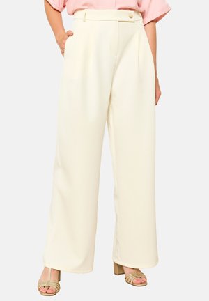 Wide-leg trousers in cream fabric with a smooth texture, featuring a high waistband, pleats, and side pockets. Simple button closure.
