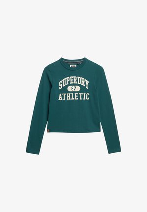 Langärmliges, cropped T-Shirt aus türkisfarbenem Baumwollstoff mit weißem Druck "SUPERDRY ATHLETIC 87". Gerippter Rundhalsausschnitt und kleines Logotag am Saum.