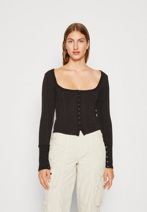 Black ribbed long-sleeve top with a square neckline and button-down front. Features slim fit, textured fabric, and button accents on sleeves.