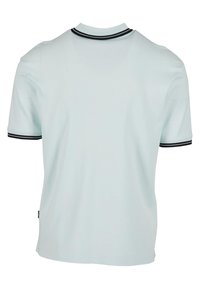 Gaiši zils īsajiem piedurknēm polo krekls, kuram ir kontrastējoši melni un balti svītroti apkakle un piedurkņu maliņas, izgatavots no gludas, mīkstas auduma.