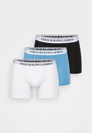 Trois paires de boxers en blanc, bleu clair et noir. Chacune présente une ceinture noir avec le logo "Polo Ralph Lauren".