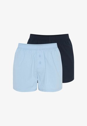 Dwie pary męskich slipów: jedna jasnoniebieska z guzikami, a druga w jednolitym czarnym kolorze, obie z elastycznym pasem i luźnym krojem.