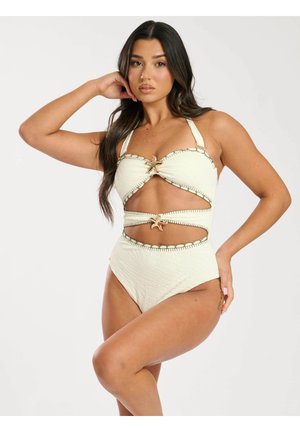 Bikini bianco a due pezzi in tessuto testurizzato, con bordi sagomati e accenti in oro a forma di stella marina al centro e tagli laterali.