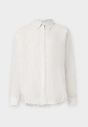 Vit skjorta med knapp-up i mjukt tyg, med subtila prickmönster och klassisk krage. Långa ärmar med knappade manschetter.