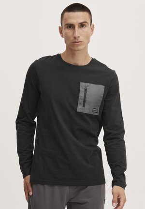 Black long-sleeve shirt with a gray zippered pocket on the left chest, featuring a rounded neckline and a soft, smooth texture.