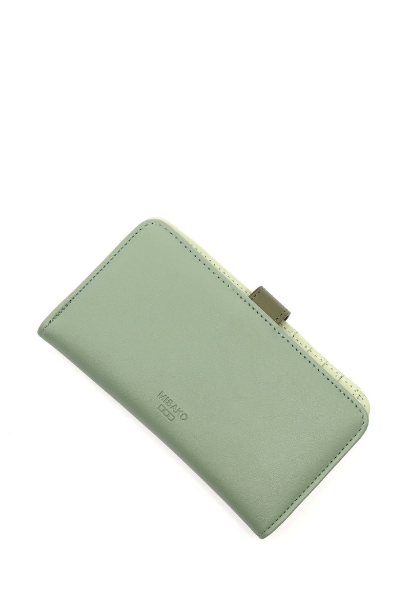 Green leather wallet with a textured light green accent, slightly rounded shape, and subtle stitching details. Logo embossed on the front.
