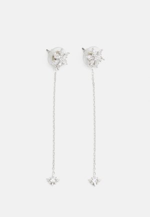 Boucles d’oreilles pendantes délicates en argent avec des clous en forme d’étoile et de petits cristaux, chacune avec une fine chaîne reliant deux motifs en forme d’étoile.