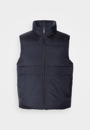 Tumedat sinise värvi puffervest kõrge kraega ja ees oleva lukuga, millel on sile, kergelt läikiv tekstuur ja horisontaalsed õmblused.